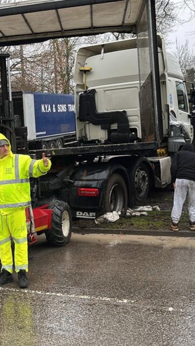 A lorry stuck in mud.