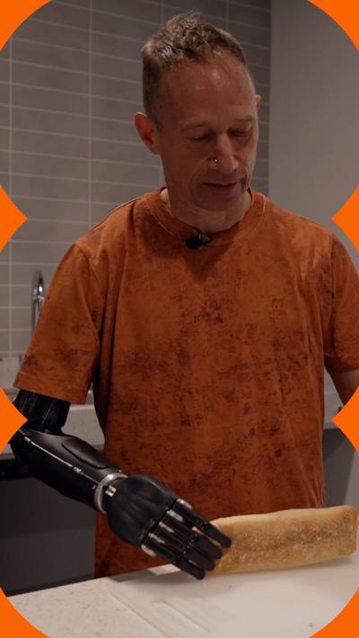 A man with a prosthetic arm holds a ciabatta 