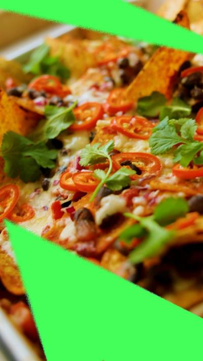 A close-up on delicious-looking loaded black bean nachos