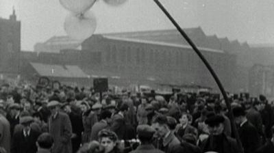 Bustling crowds at Bethnal Green market.