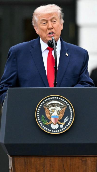 Donald Trump speaks behind the presidential podium.