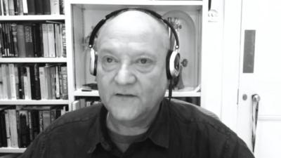 Prof. Russell Foster speaking and wearing headphones