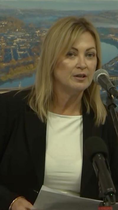 A woman speaking into a microphone