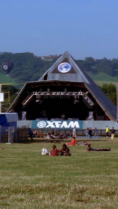 A photo shows the pyramid stage at Glastonbury Festival.