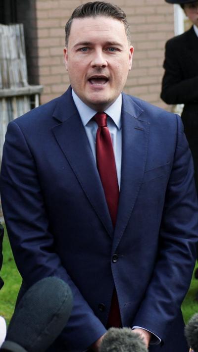 Wes Streeting wearing a suit and a tie 