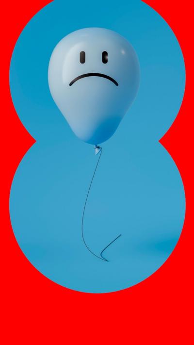 A blue balloon with a sad face on a blue background
