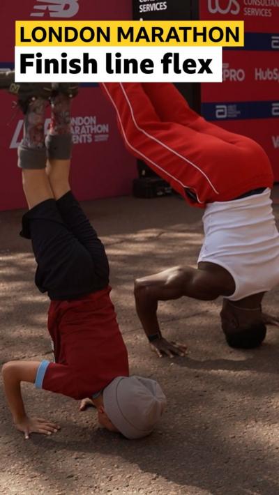 Dylan Valavan and Harry Aikines-Aryeetey do a headstand at the finish line of the Mini London Marathon
