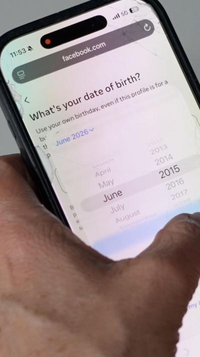 A phone screen that reads 'What's your date of birthday?'