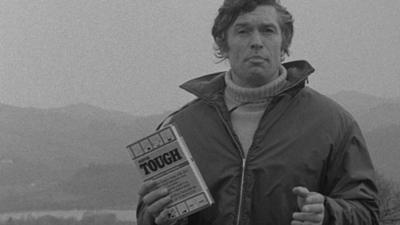 Bob Langley holds a copy of Tony Greenbank's book, Mr Tough