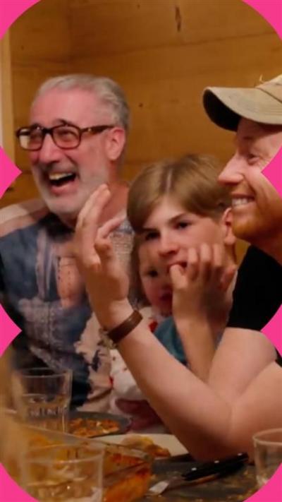 Joe Swash displays his hand to family members who are laughing