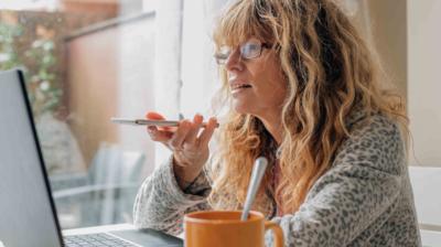 Woman looking at her laptop and talking on her phone