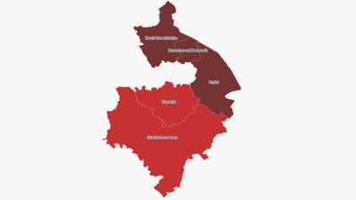  Map of Warwickshire against a white background with the north area shown in maroon with the words North Warwickshire, Nuneato and Bedworth and Rugby. The south of the county is shown in red with the words Warwick and Stratford-on-Avon showing. 
