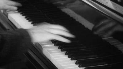 A pair of hands play the piano