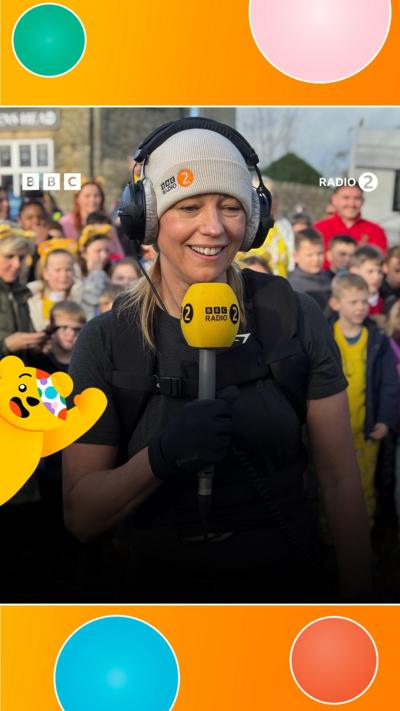 Sara Cox with a microphone