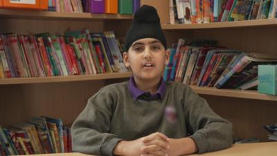 Boy sat at school desk