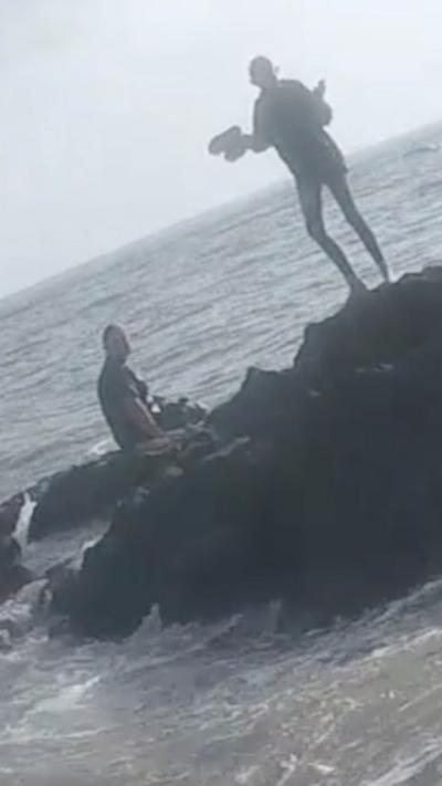 Kids trapped on rock