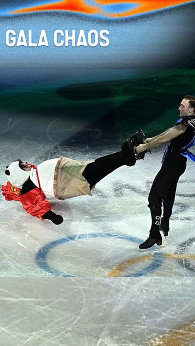 A figure skater dressed as Sub Zero spins another skater dressed as a panda by his ankles