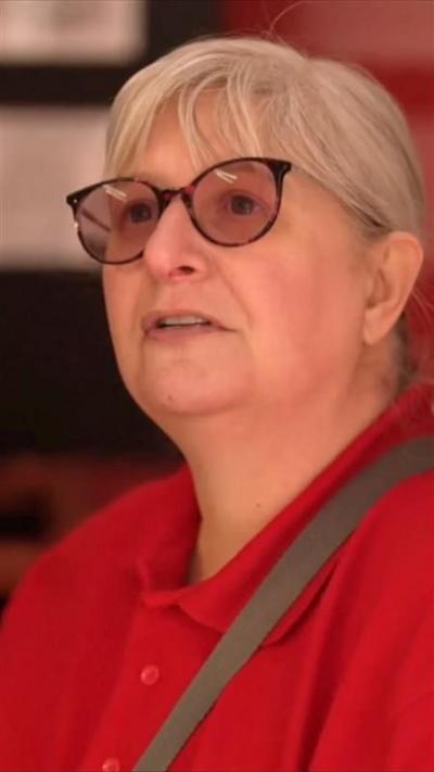 A woman answers questions inside a shop