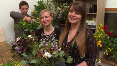 women and men in flower arranging class