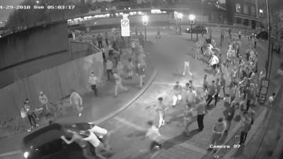 CCTV footage of people surrounding a car