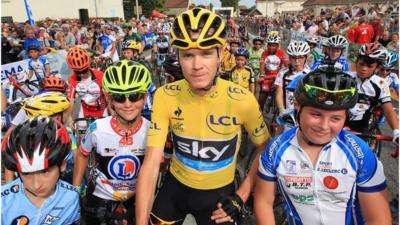 Tour de France winner Chris Froome with young cyclists before a race in France