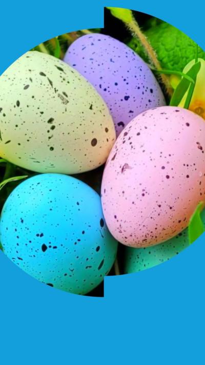 Several brightly-coloured speckled eggs nestled in some grass.