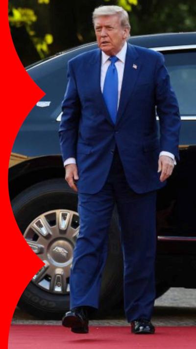 Donald Trump in a blue suit, on the red carpet after exiting a car in the Netherlands