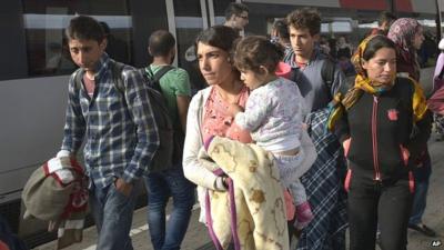 Migrants arrive at the Westbahnhof station in Vienna, Austria, after arriving from Hungary