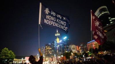 A protester holds a flag that reads "Hong Kong Independence" near the government's headquarters in Hong Kong on August 5, 2016