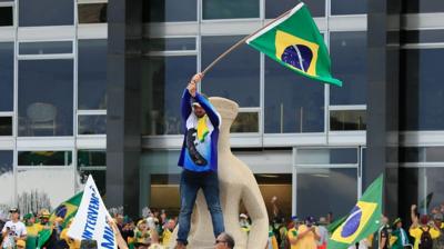 Man waving Brazil flag