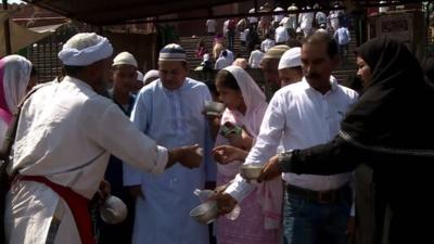 Indian bhishti distributes water