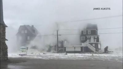 Waves batter houses