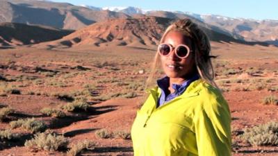 Hafida standing in front of mountains