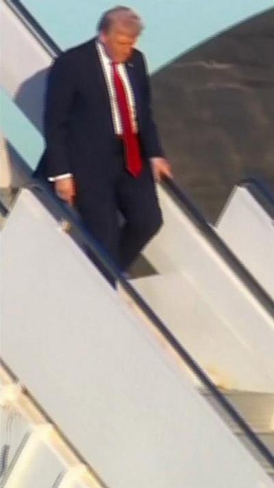American President Donald Trump getting walking down the stairs of Air Force One