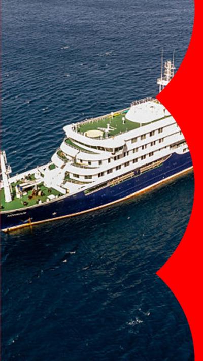 Aerial view of a cruise ship in a large body of blue water