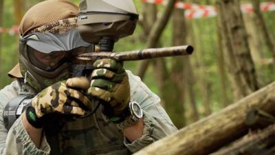 Man shooting a paintball gun