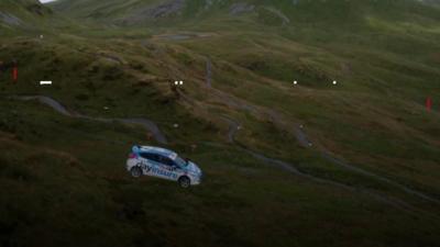 A rally car going down a zip wire