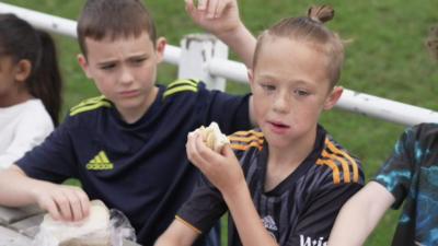 Boy holding sandwich