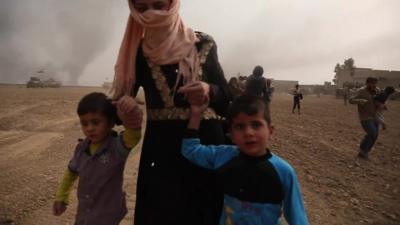 Children flee from a village in Iraq as Iraqi soldiers advance