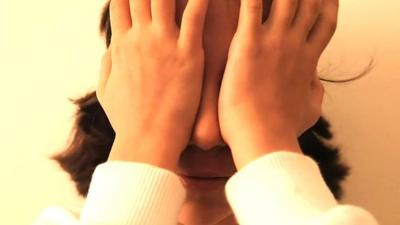 A girl covering her eyes