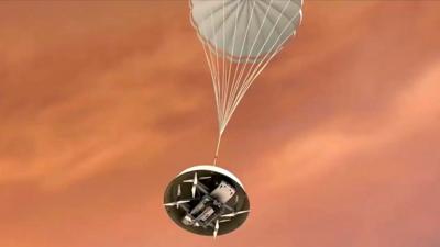 A graphic of a parachute dropping a robotic copter onto Saturn's moon Titan