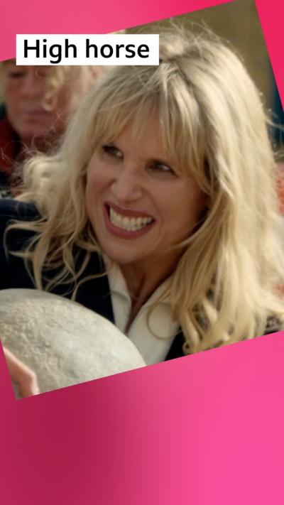 A woman, Amanda, grimaces. She has blonde hair