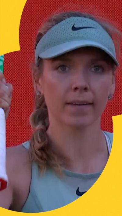 Katie Boulter holds racket up
