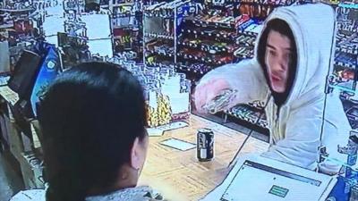 Armed robber points gun at cashier