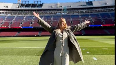 A woman stands on the field at Barca's new Camp Nou