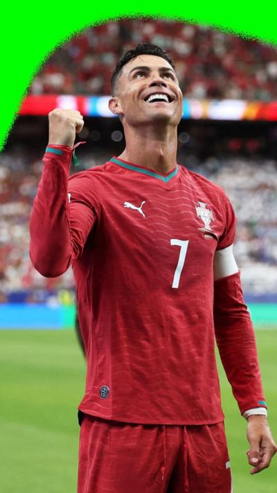 Cristiano Ronaldo celebrates by smiling at the fans after scoring a second goal for Portugal against Uzbekistan