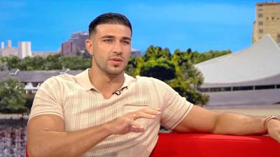Tommy Fury wearing a beige polo shirt during an interview in the BBC Breakfast studio