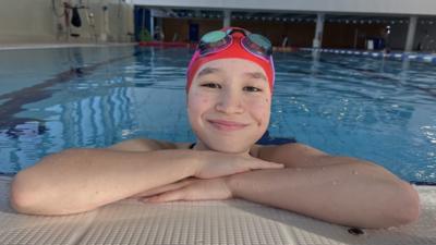 Andrea in the pool smiling