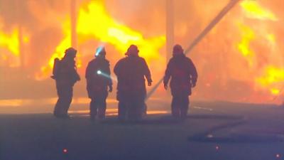 Firefighters trying to put out a blaze in Chile