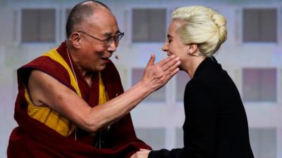The Dalai Lama greets Lady Gaga
